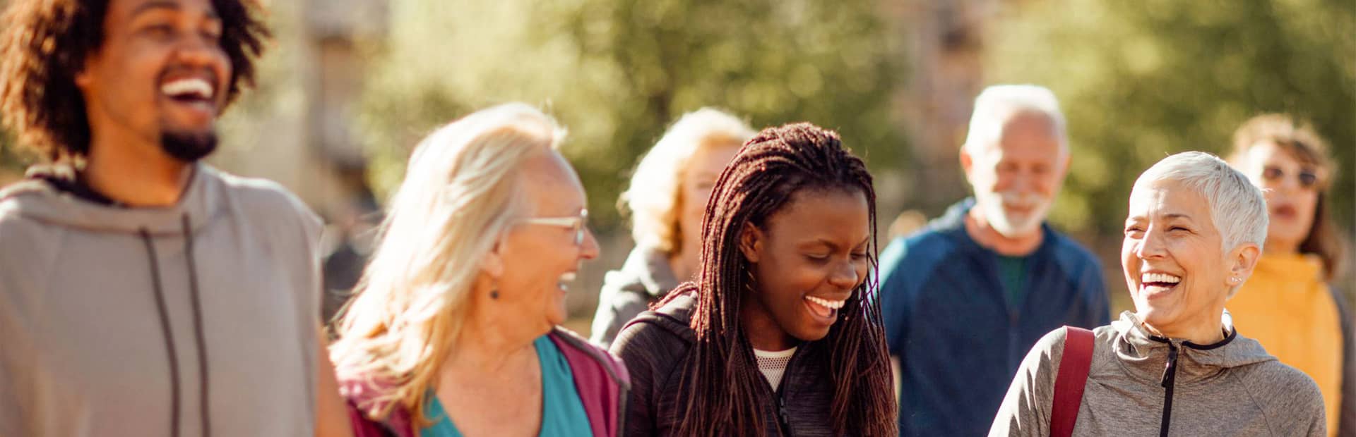 Promisecare Medical Group - A group of people participating in FREE health education programs while walking together in a park.