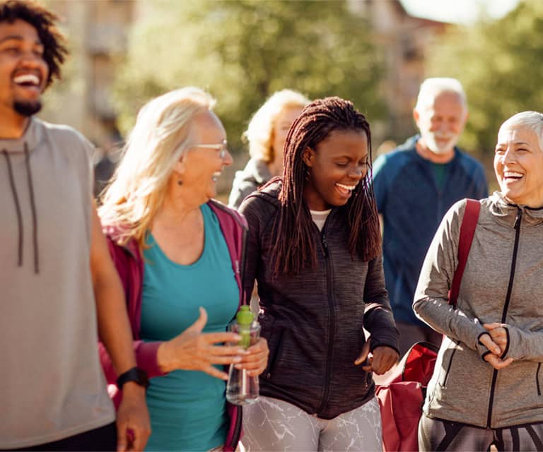 Promisecare Medical Group - A group of people participating in FREE Health Education Programs while walking together in a park.