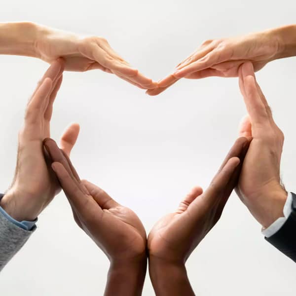 Promisecare Medical Group - A group of people participating in FREE health education programs while making a heart shape with their hands.