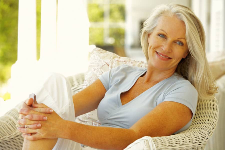 Promisecare Medical Group - An older woman sitting in a wicker chair during the Medicare Annual Enrollment Period for 2024.