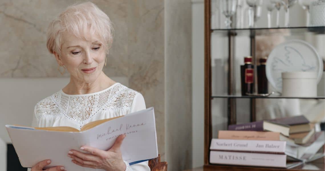 Promisecare Medical Group - A woman is reading a book in her living room.