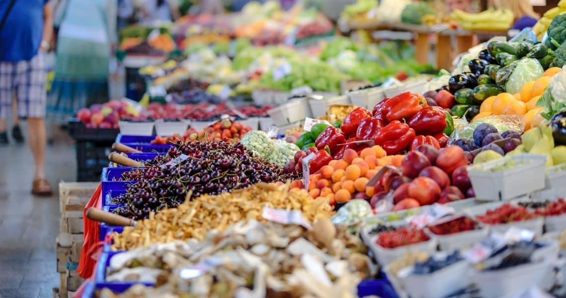 Promisecare Medical Group - Colorful fresh produce displayed at a bustling market stall.