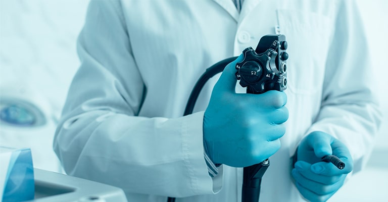 Promisecare Medical Group - A person in a lab coat is holding an Addiction Medicine device.