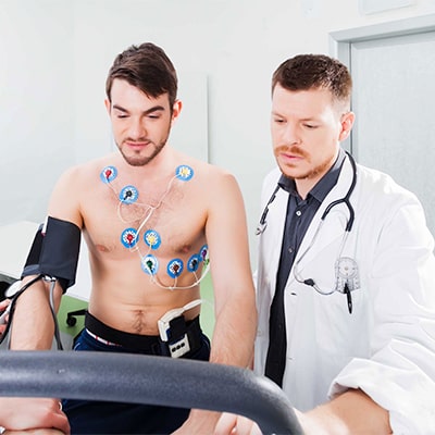 Promisecare Medical Group - An addiction medicine doctor and a patient are working on a machine.