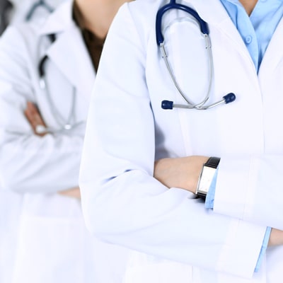 Promisecare Medical Group - A group of doctors showcasing their professional services by standing in a row with their arms crossed.