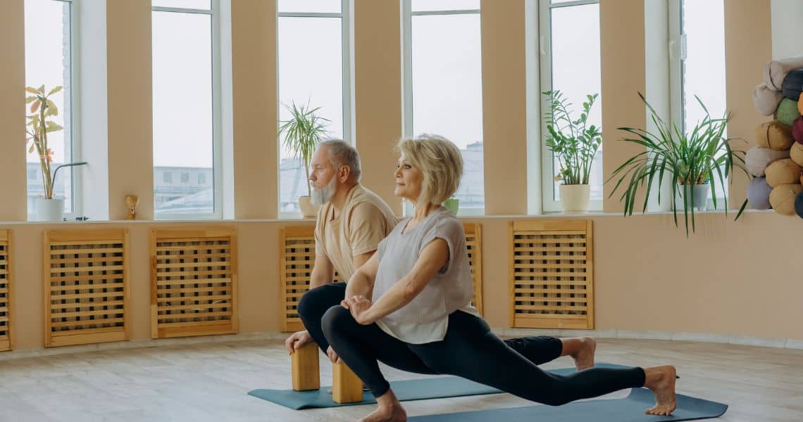 Promisecare Medical Group - A man and woman doing yoga in a room.
