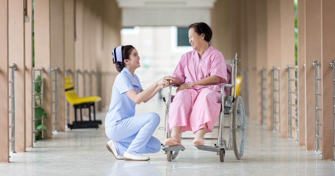 Promisecare Medical Group - A nurse in a wheelchair is helping another woman.