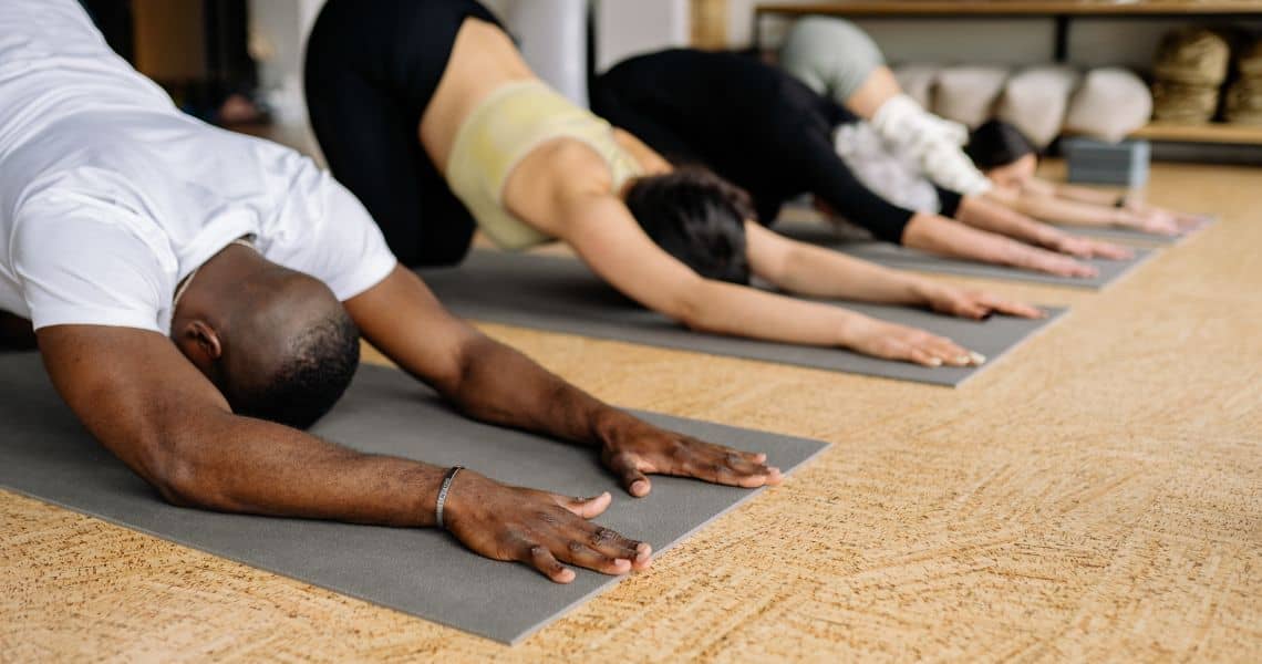 Promisecare Medical Group - A group of people doing yoga in a gym.