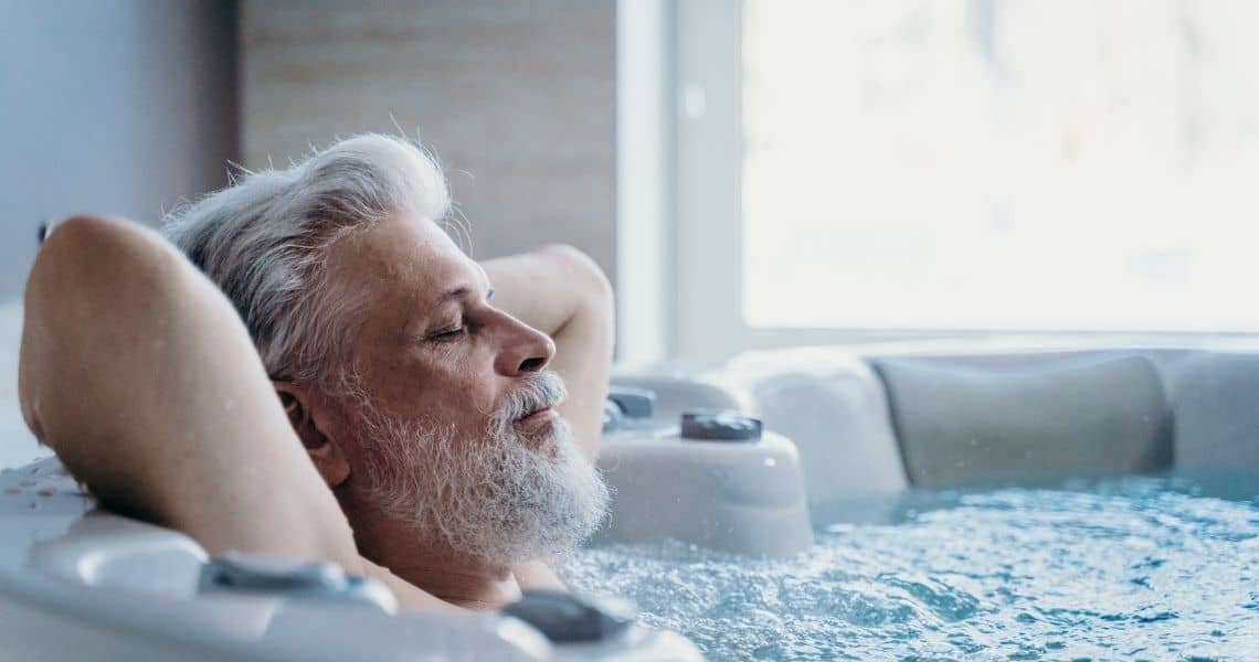 Promisecare Medical Group - Senior man rejuvenating in a hot tub.