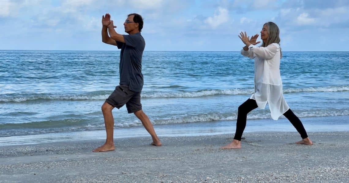 Promisecare Medical Group - Two people practicing tai chi on the beach as part of their Spring Fitness Revival routine.